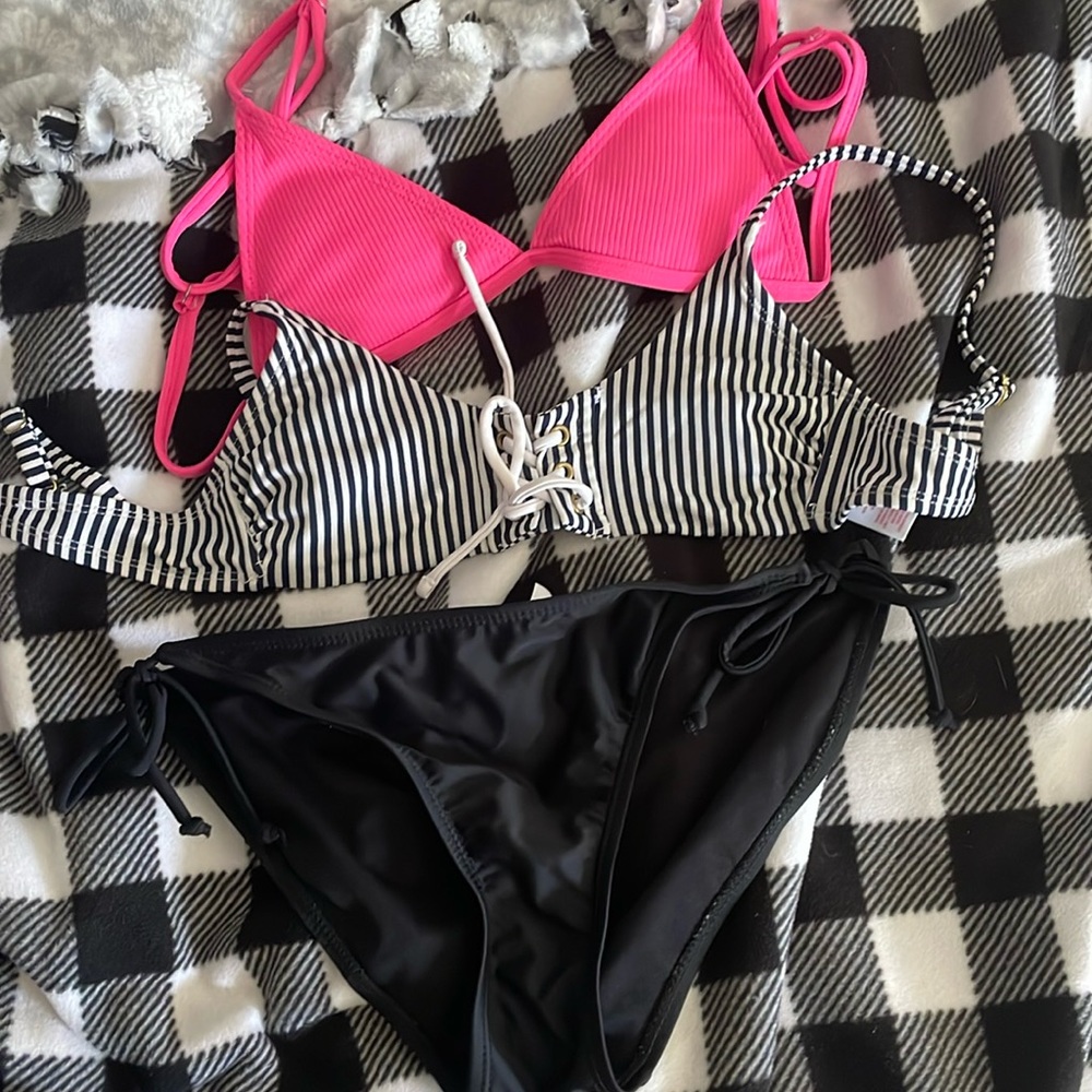 Pink bathing suit top, blue bathing suit top, black bottoms